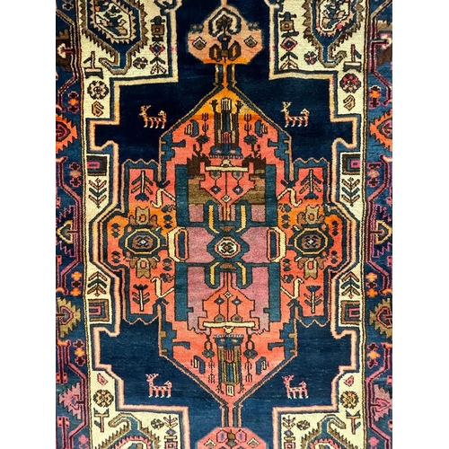 966 - A 20th century Persian Islamic North West Viz flor rug carpet having central polychrome medallion of... 