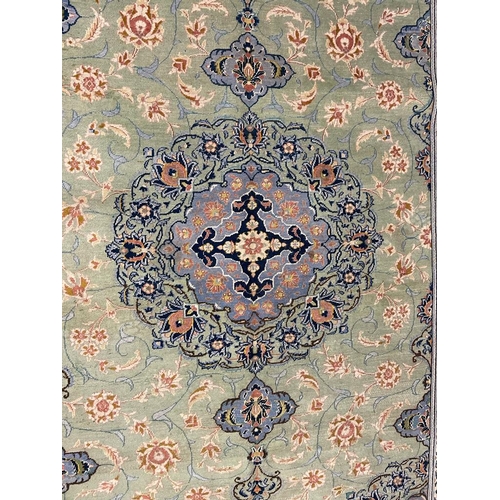 971 - A 20th century Central Persian Islamic Kashan floor rug carpet having a floral shaped central medall... 