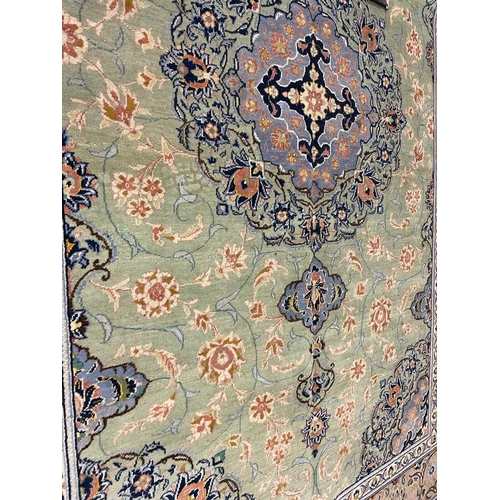 971 - A 20th century Central Persian Islamic Kashan floor rug carpet having a floral shaped central medall... 