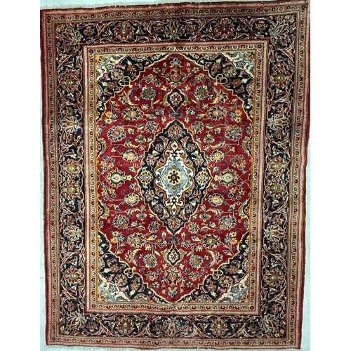 972 - A 20th century Central Persian Islamic Kashan floor rug carpet having a central medallion in light b... 