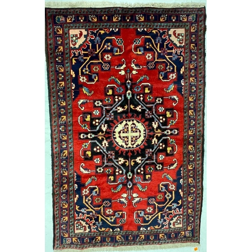 973 - A 20th century North West Persian Islamic Tafresh floor rug carpet having a central shaped medallion... 