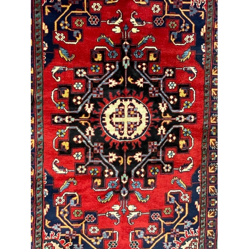 973 - A 20th century North West Persian Islamic Tafresh floor rug carpet having a central shaped medallion... 