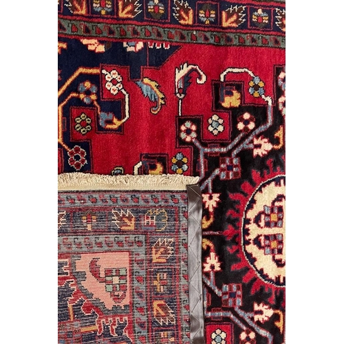 973 - A 20th century North West Persian Islamic Tafresh floor rug carpet having a central shaped medallion... 