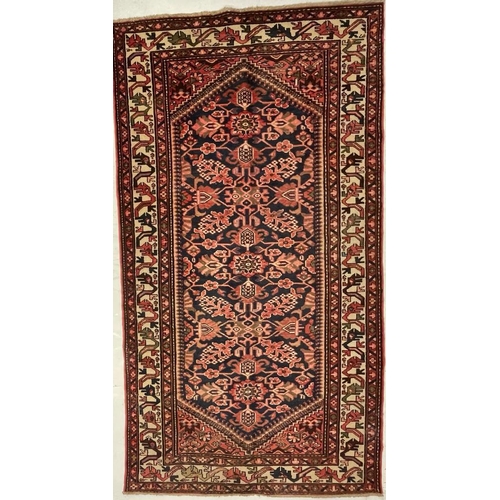 976 - A 20th century North West Persian Islamic Malayer floor rug carpet having a central panel decorated ... 