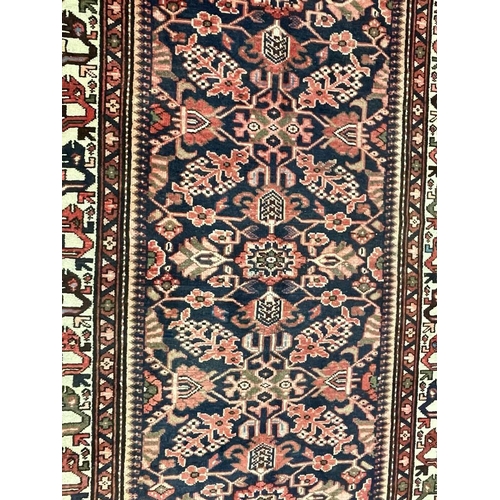 976 - A 20th century North West Persian Islamic Malayer floor rug carpet having a central panel decorated ... 