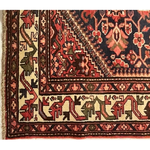976 - A 20th century North West Persian Islamic Malayer floor rug carpet having a central panel decorated ... 