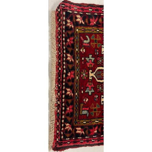 980 - A 20th century North West Persian Islamic Heriz floor rug carpet runner having a series of repeating... 