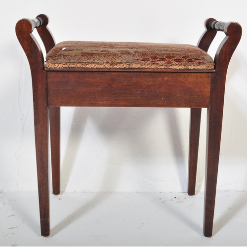 982 - An Edwardian mahogany piano stool seat. Raised on squared legs with upholstered seat having hinged t... 