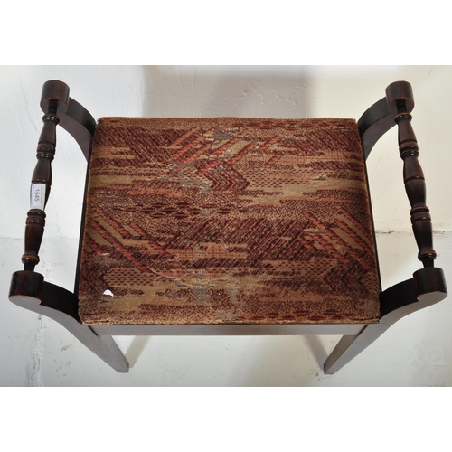 982 - An Edwardian mahogany piano stool seat. Raised on squared legs with upholstered seat having hinged t... 