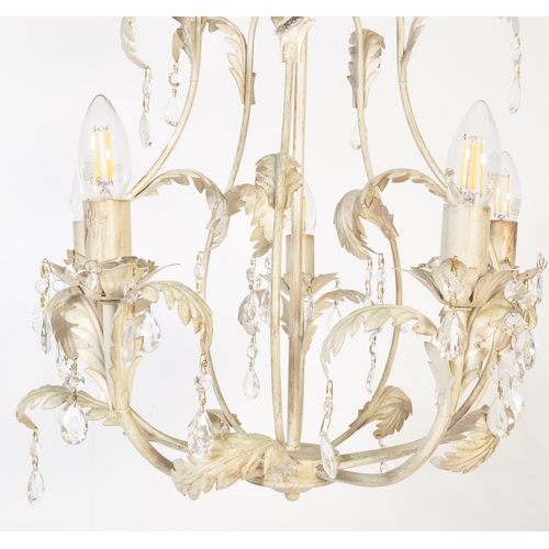 985 - A 20th century painted metal Toleware five arm chandelier. The chandelier being painted white having... 