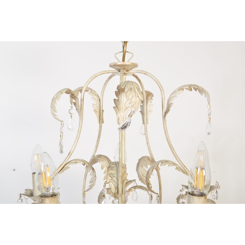 985 - A 20th century painted metal Toleware five arm chandelier. The chandelier being painted white having... 