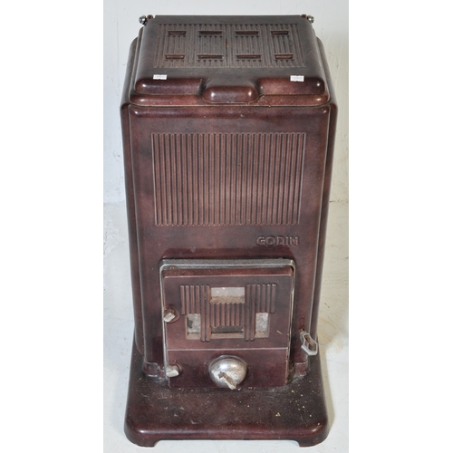 947 - An early 20th century French Godin cast iron log burning stove in a burgundy colourway. Temperature ... 