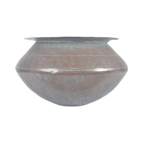 1076 - An 18th Century Indonesian copper serving pot of bulbous circular form having a flat circular rim ov... 