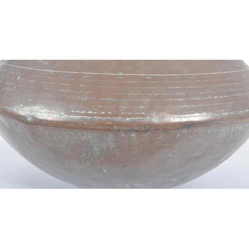 1076 - An 18th Century Indonesian copper serving pot of bulbous circular form having a flat circular rim ov... 