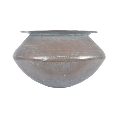 1076 - An 18th Century Indonesian copper serving pot of bulbous circular form having a flat circular rim ov... 
