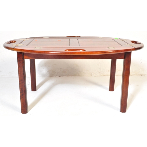 1055 - A 20th century mahogany and brass bound butlers tray coffee table with panelling to top over squared... 