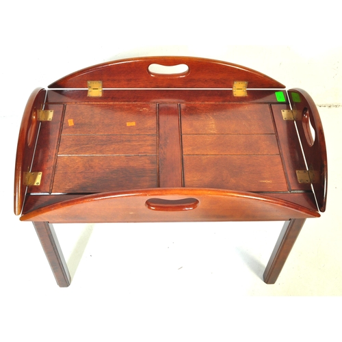 1055 - A 20th century mahogany and brass bound butlers tray coffee table with panelling to top over squared... 