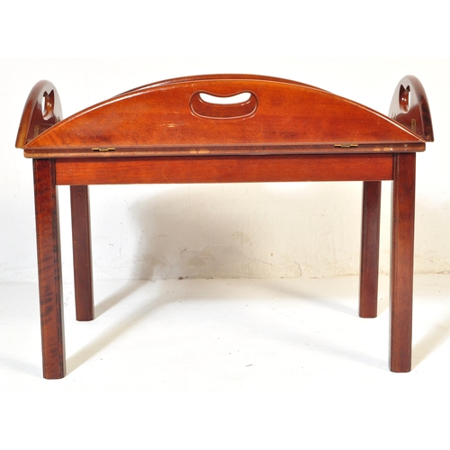 1055 - A 20th century mahogany and brass bound butlers tray coffee table with panelling to top over squared... 