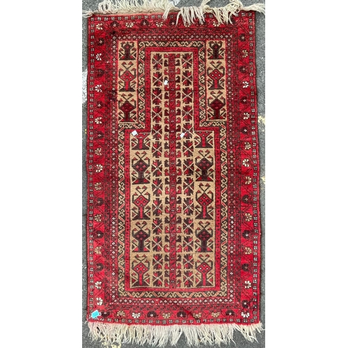 964 - A vintage 20th Century Persian Islamic Baluch prayer floor carpet rug. Having central geometric pane... 
