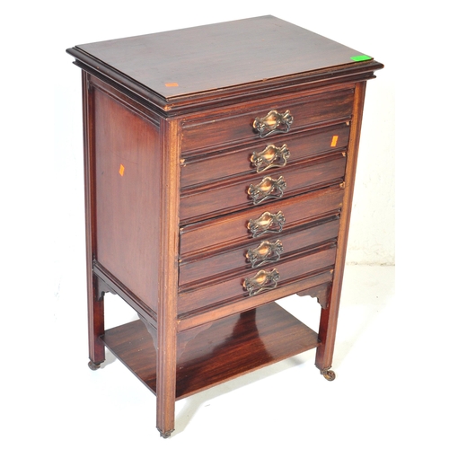 1054 - An early 20th century circa. 1920's mahogany music cabinet having a bank of six pull out drawers, ea... 