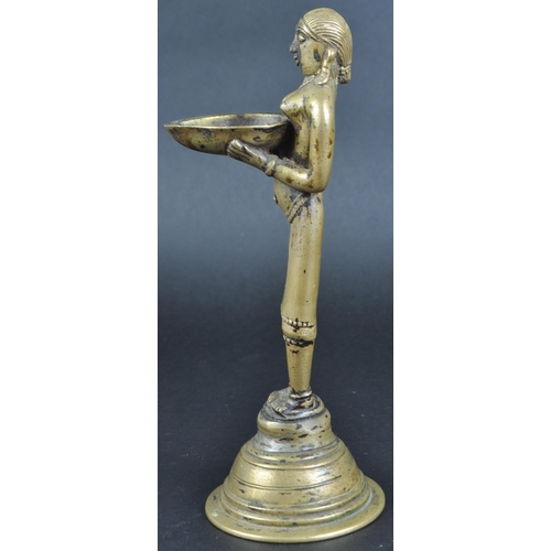 123 - An early 20th Century African Tribal white metal figurine depicting a servant girl. The figure model... 