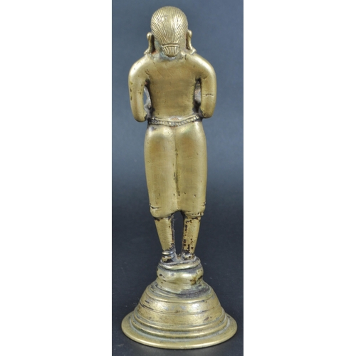 123 - An early 20th Century African Tribal white metal figurine depicting a servant girl. The figure model... 