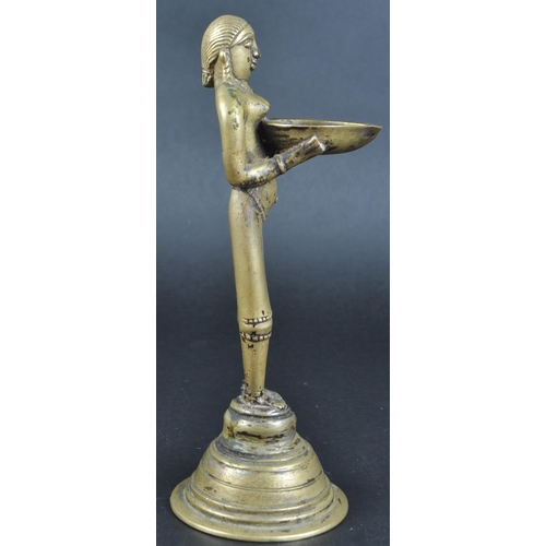 123 - An early 20th Century African Tribal white metal figurine depicting a servant girl. The figure model... 