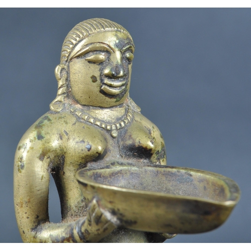 123 - An early 20th Century African Tribal white metal figurine depicting a servant girl. The figure model... 