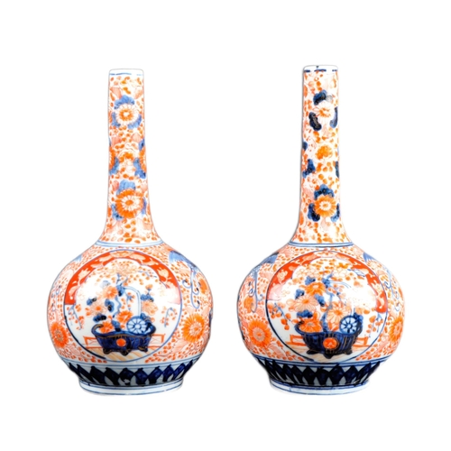 125 - A pair of 19th Century Japanese Meiji period Imari porcelain bottle vases. Tapering cylindrical neck... 
