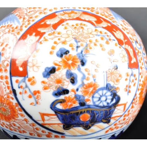 125 - A pair of 19th Century Japanese Meiji period Imari porcelain bottle vases. Tapering cylindrical neck... 