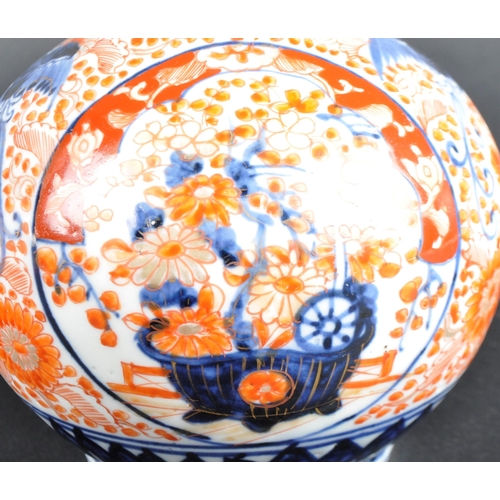 125 - A pair of 19th Century Japanese Meiji period Imari porcelain bottle vases. Tapering cylindrical neck... 