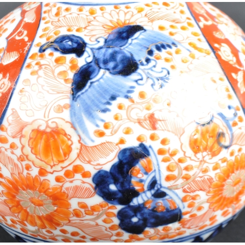 125 - A pair of 19th Century Japanese Meiji period Imari porcelain bottle vases. Tapering cylindrical neck... 