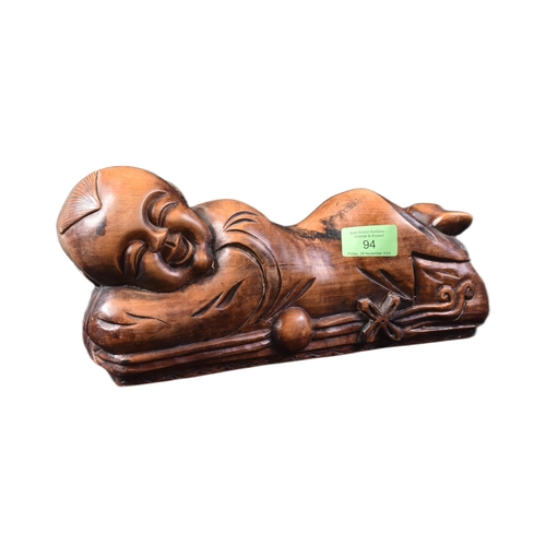 128 - A 20th Century Chinese hand carved headrest pillow in the form of a sleeping child. Detailed carved ... 