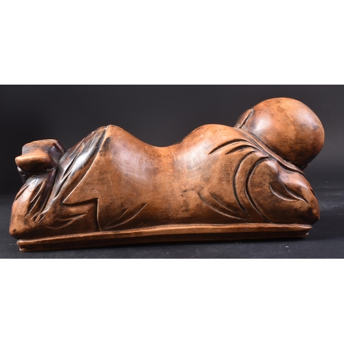 128 - A 20th Century Chinese hand carved headrest pillow in the form of a sleeping child. Detailed carved ... 