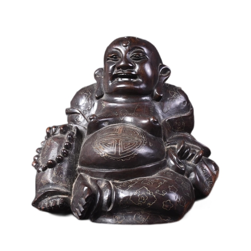 129 - An early 20th Century Chinese hardwood carved figurine of Buddha. The pot bellied figure modelled si... 