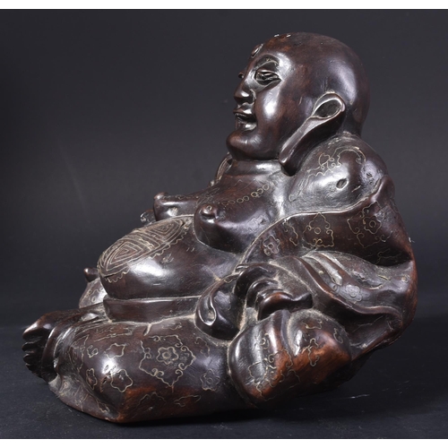 129 - An early 20th Century Chinese hardwood carved figurine of Buddha. The pot bellied figure modelled si... 