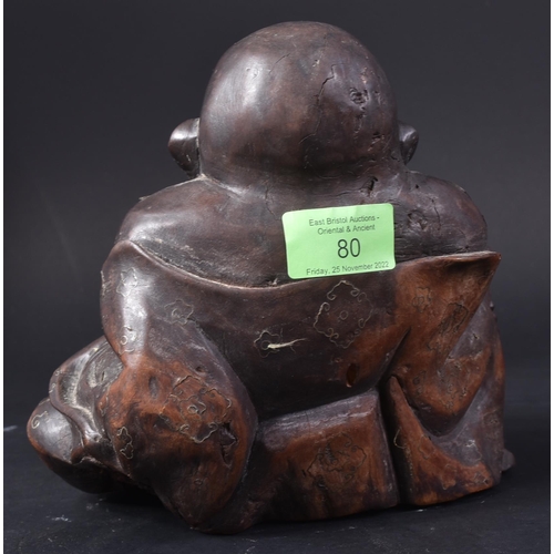 129 - An early 20th Century Chinese hardwood carved figurine of Buddha. The pot bellied figure modelled si... 
