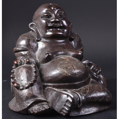 129 - An early 20th Century Chinese hardwood carved figurine of Buddha. The pot bellied figure modelled si... 