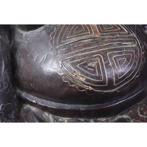 129 - An early 20th Century Chinese hardwood carved figurine of Buddha. The pot bellied figure modelled si... 