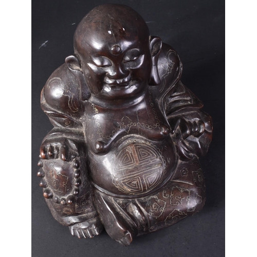 129 - An early 20th Century Chinese hardwood carved figurine of Buddha. The pot bellied figure modelled si... 