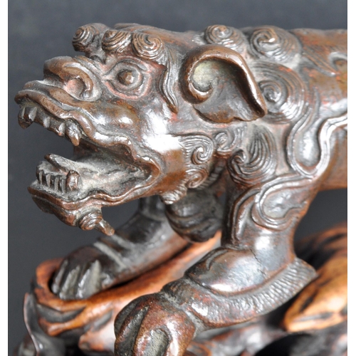 133 - An 18th Century Chinese bronze Foo Dog. The figure modelled standing with detailed features, open ja... 