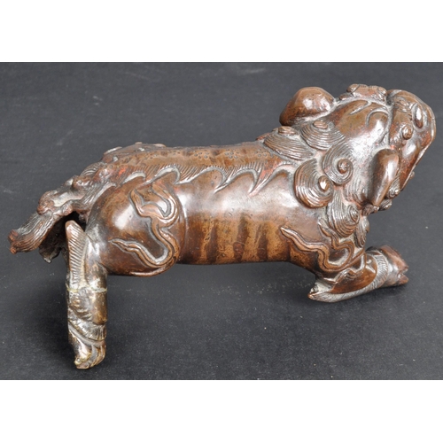 133 - An 18th Century Chinese bronze Foo Dog. The figure modelled standing with detailed features, open ja... 