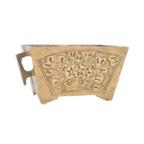 136 - An early 20th Century Chinese bronze censer ding bowl having engraved panels with twin archaic handl... 