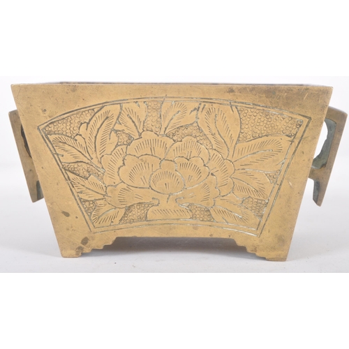 136 - An early 20th Century Chinese bronze censer ding bowl having engraved panels with twin archaic handl... 