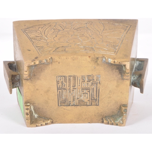 136 - An early 20th Century Chinese bronze censer ding bowl having engraved panels with twin archaic handl... 