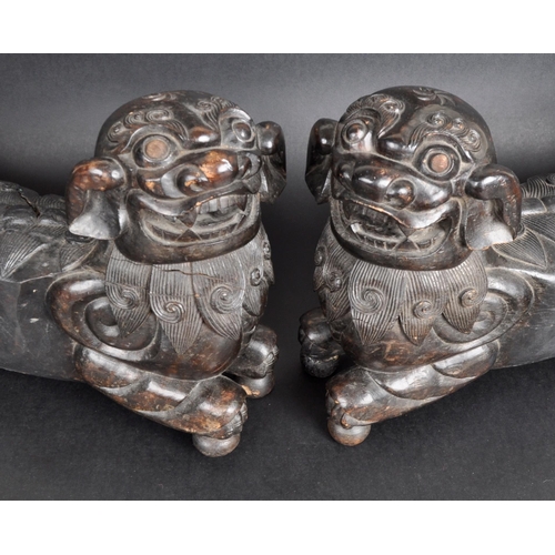 137 - A large pair of 19th Century Chinese hand carved hardwood foo dogs / temple lions. Elongated form wi... 