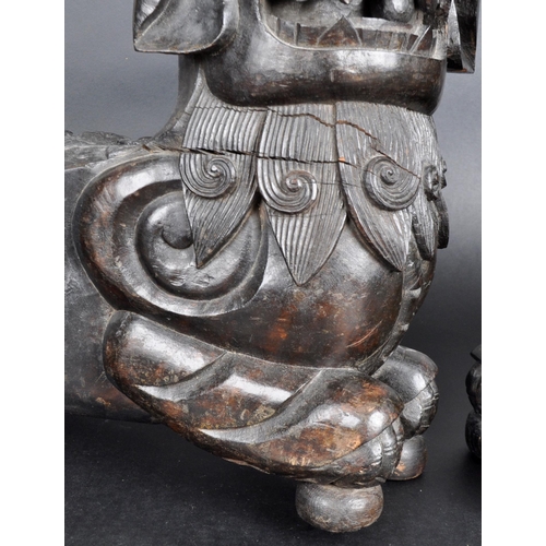 137 - A large pair of 19th Century Chinese hand carved hardwood foo dogs / temple lions. Elongated form wi... 
