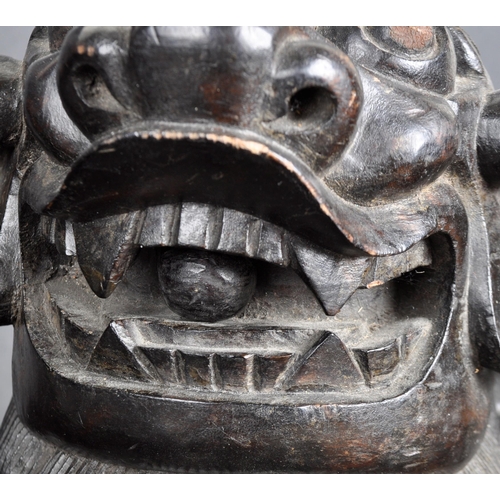 137 - A large pair of 19th Century Chinese hand carved hardwood foo dogs / temple lions. Elongated form wi... 