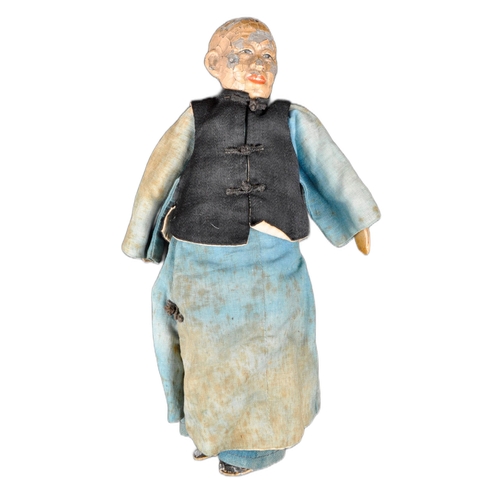 138 - A 19th Century Chinese doll. Painted features to head with hand made robe & jacket and painted shoes... 