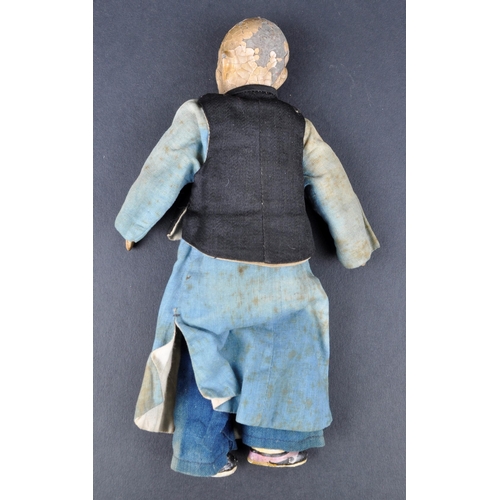 138 - A 19th Century Chinese doll. Painted features to head with hand made robe & jacket and painted shoes... 